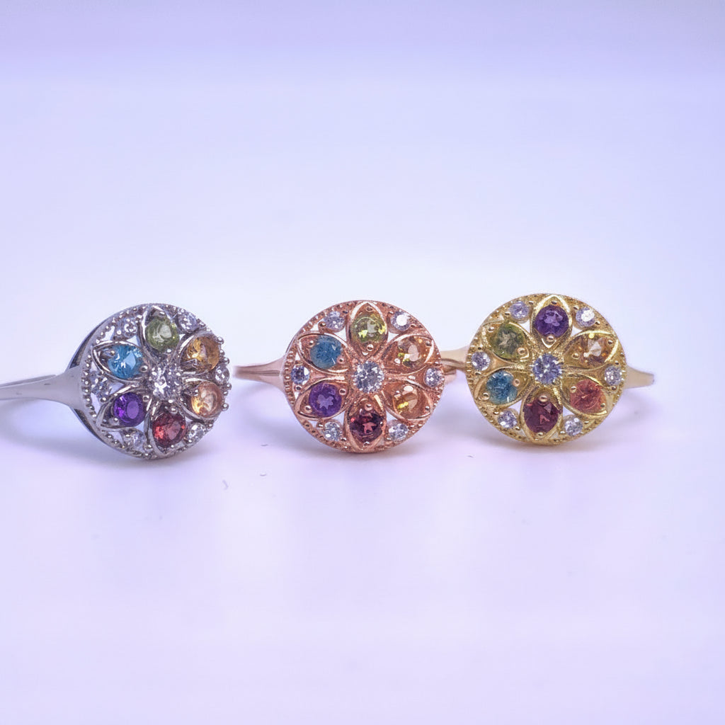 Three decorative Rings with colorful gemstones on a white background
