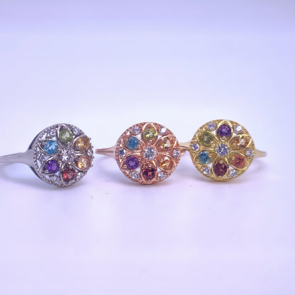 Three decorative Rings with colorful gemstones on a white background