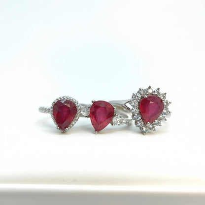 Pair of earrings with red gemstones on a white background