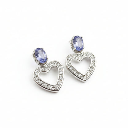 Heart-shaped earrings with Tanzanite stones on a black velvet background